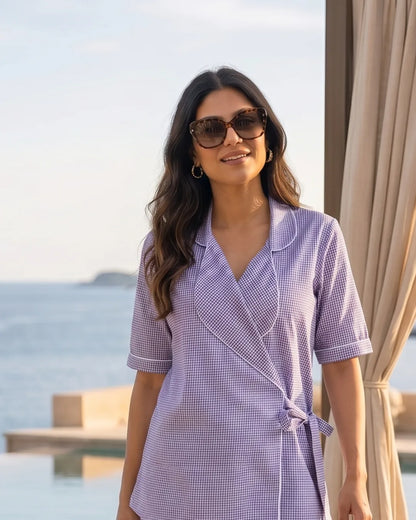 Woman wearing Story Book Wrap Top Wide Leg Trouser Set Piping and sunglasses by a curtain with a scenic background