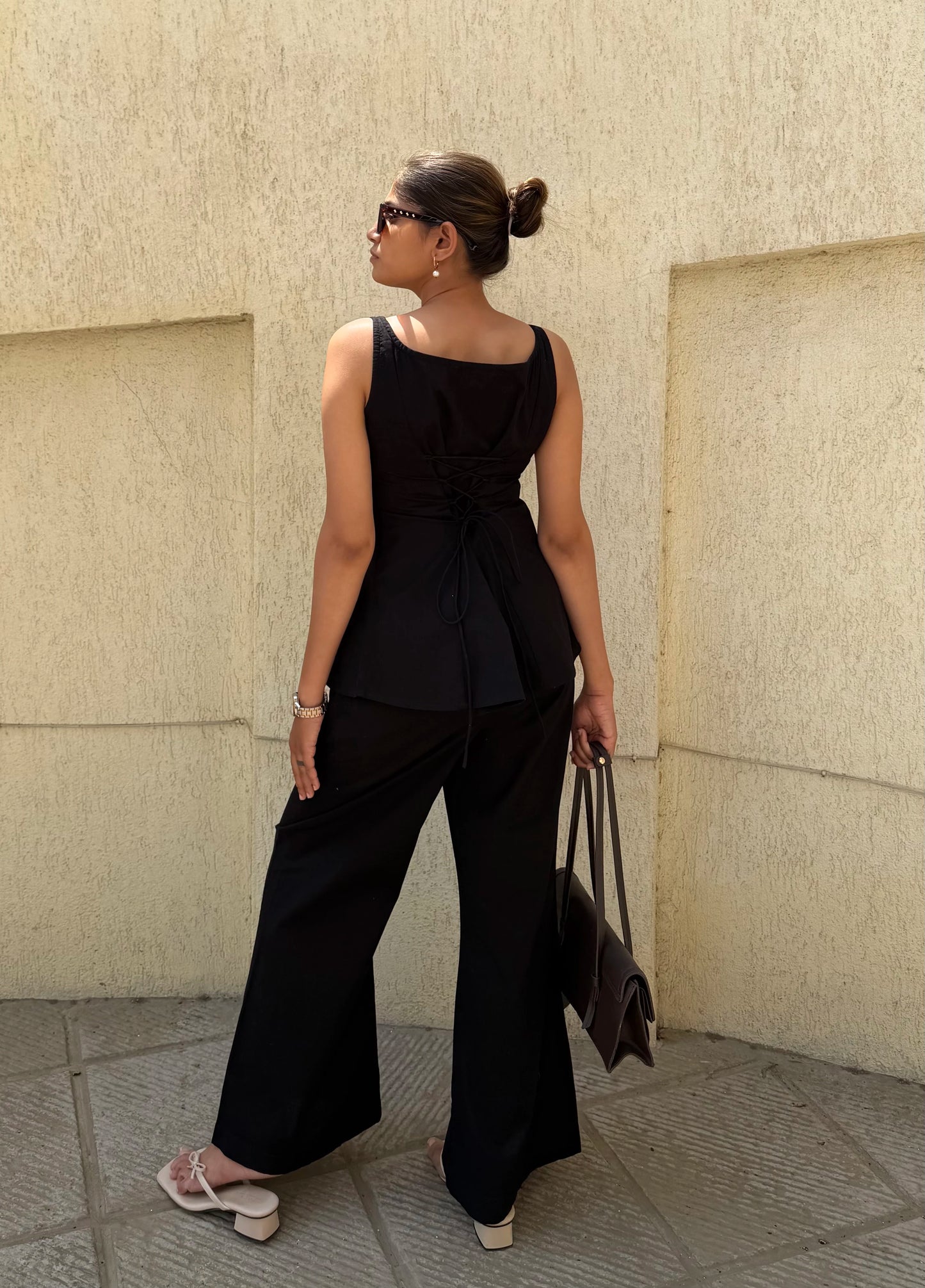Woman in Sunday in St Tropez Black Co Ord Set Wide Leg back view